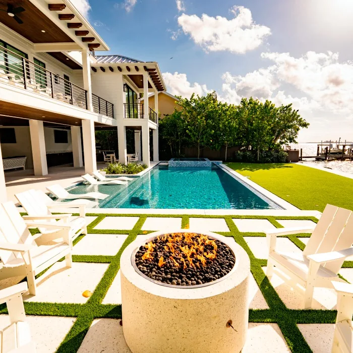 Large residential property showcasing a pool and patio, designed by Elements Oasis Pool Luxury